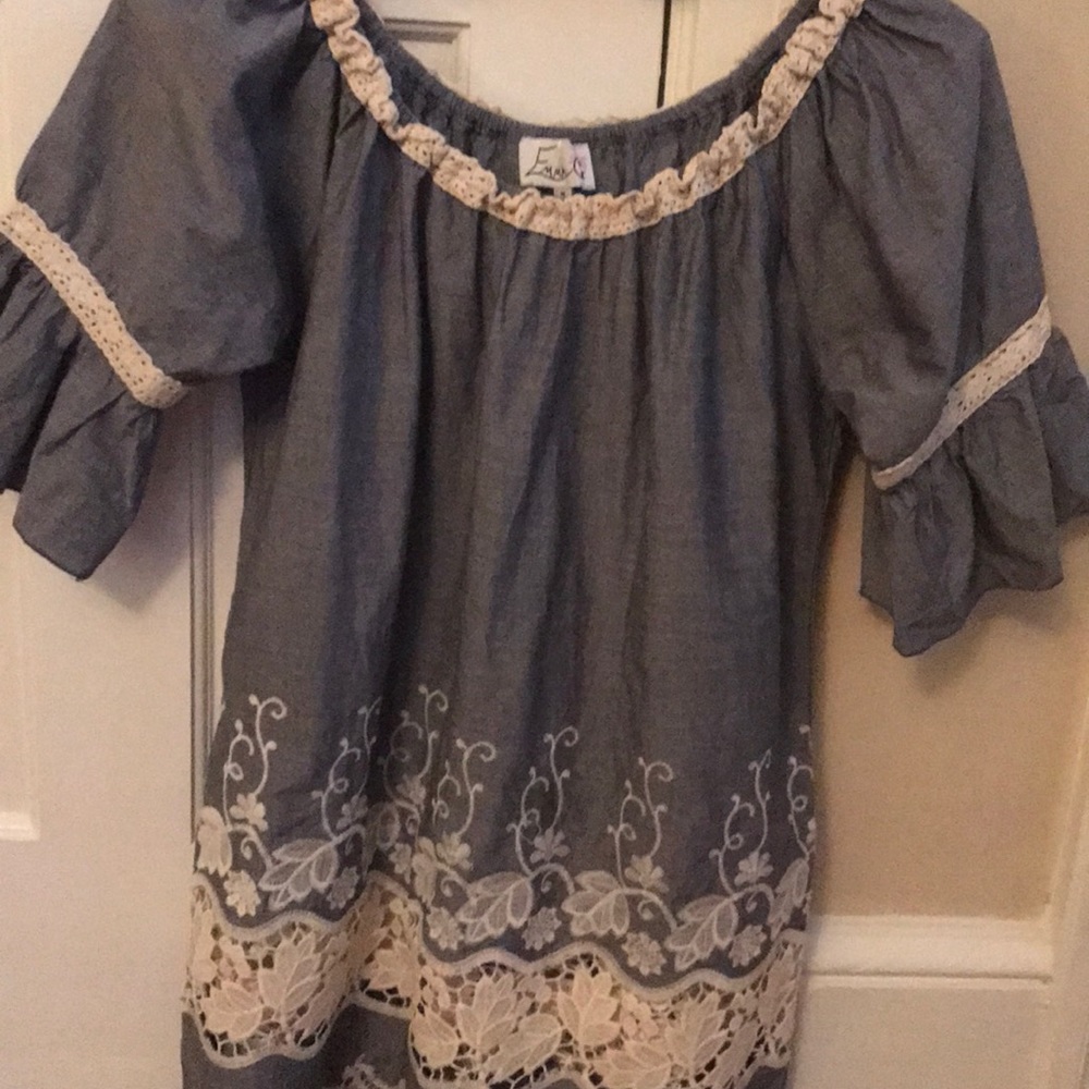 Blue blouse with off white lace insert at bottom.